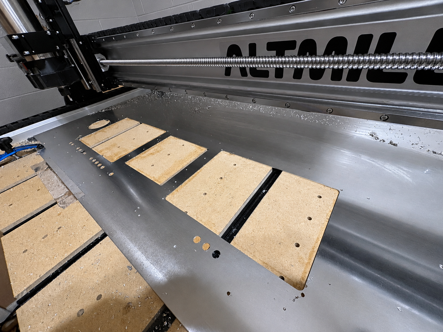 Avionics assembly workbench with tools, instruments, and panel components at SAC Aero Design